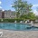Large sparkling blue pool with a large pool deck and lounge chairs