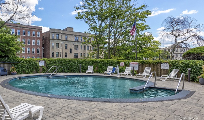 Swimming Pool Large sparkling blue pool with a large pool deck and lounge chairs
