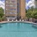 Large sparkling blue pool with a large pool deck and lounge chairs